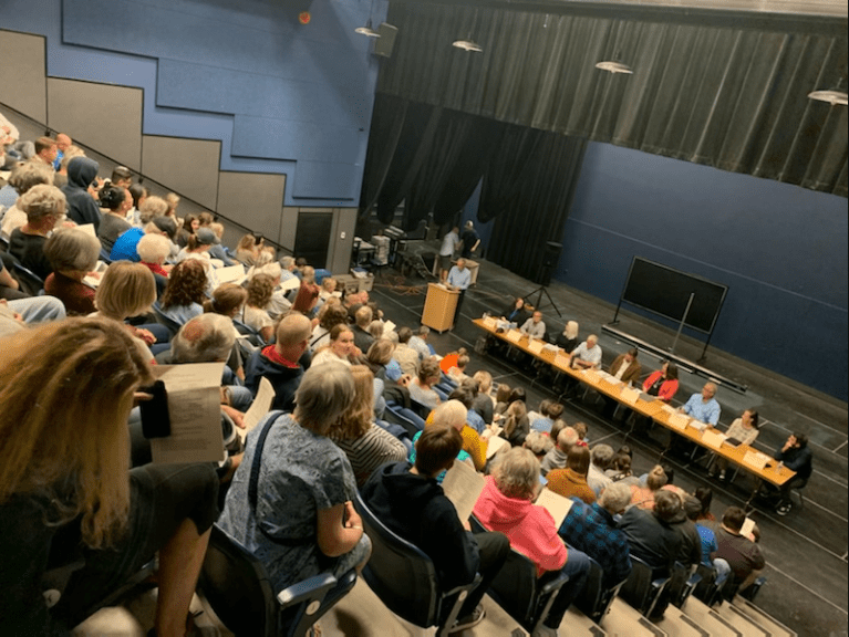 An audience attends an all-candidates debate.