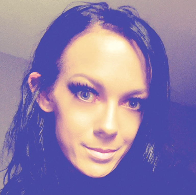 a headshot of a woman with dark sholder length hair.