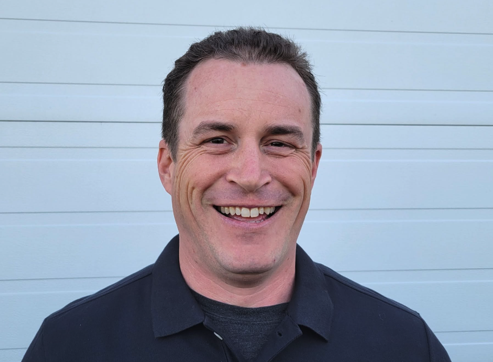 Head and shoulder shot of a man wearing a dark shirt.