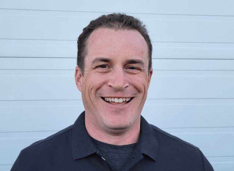 Head and shoulder shot of a man wearing a dark shirt.