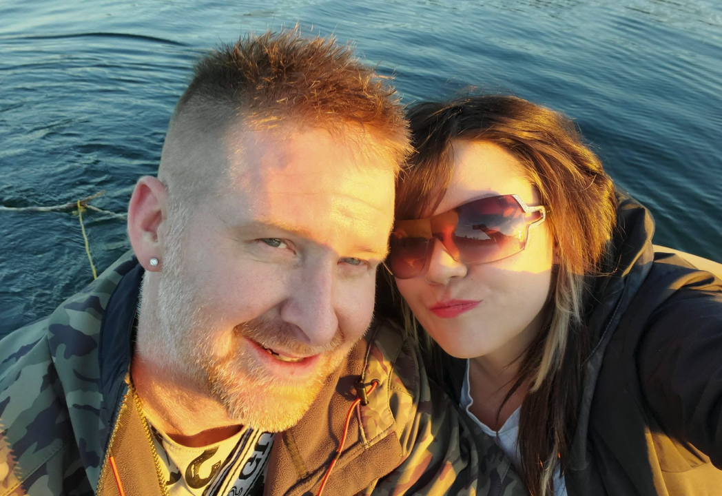 a selfie of a couple by the water.