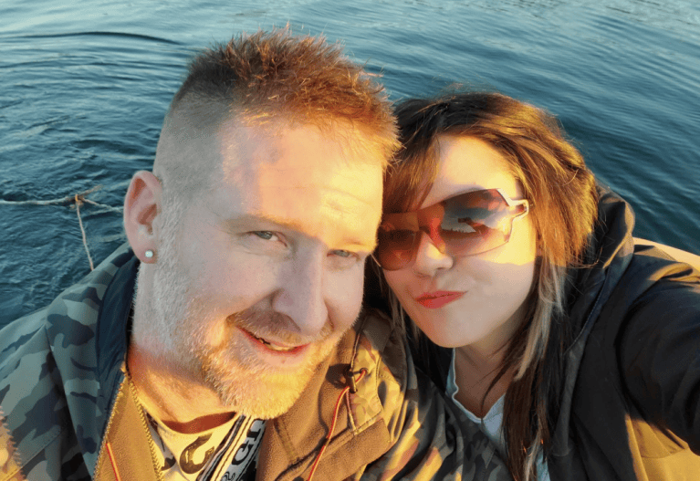 a selfie of a couple by the water.