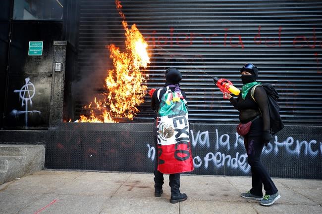 Mexican women paint, march to protest gender violence | iNFOnews.ca