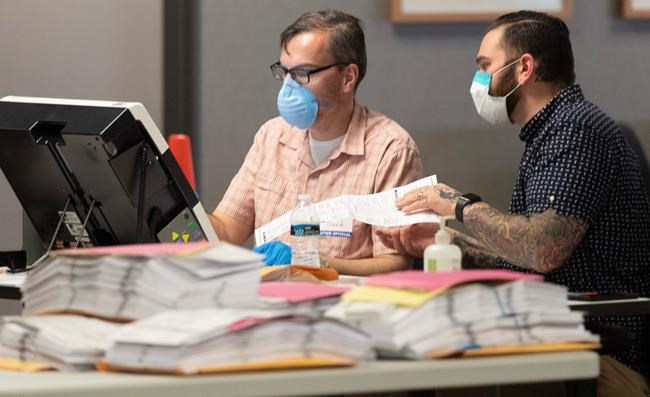 Officials: 7 virus cases may be related to in-person voting | iNFOnews.ca CP1838239483