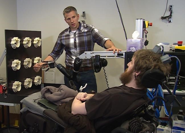 Obama shakes mind-controlled robot hand wired to sense touch | iNFOnews.ca CP397892844