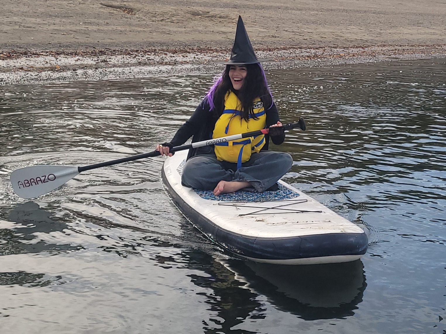 A witch paddling at the last spooky outdoor adventure event