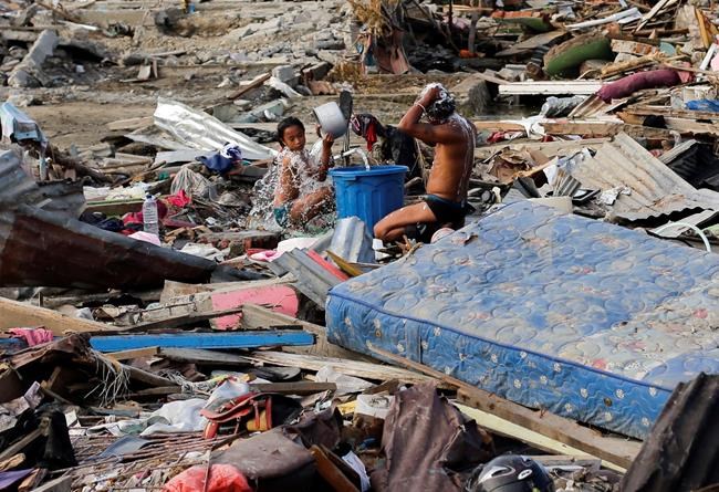 The Latest: Indonesia mulls making quake areas mass graves | iNFOnews.ca CP1083966275