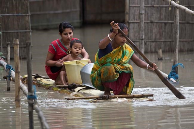Image of Asia: Flooded villagers paddle for drinking water | iNFOnews.ca