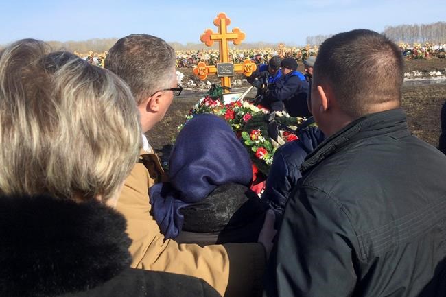 Grief overwhelms Kemerovo as whole families are buried | iNFOnews.ca CP610583929
