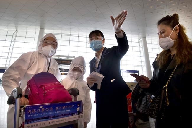 Masked crowds fill Wuhan's streets, trains as lockdown ends | iNFOnews.ca CP87950254