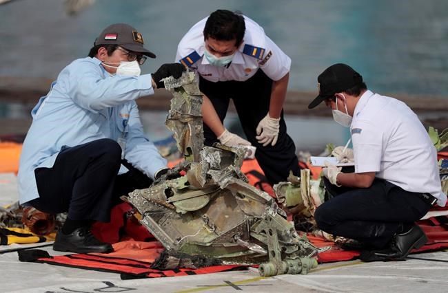 Relatives of plane's victims cast flowers into Indonesia sea | iNFOnews.ca