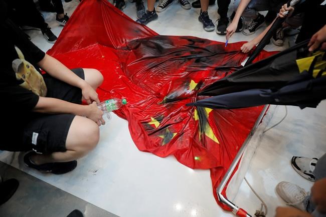 The Latest: Hong Kong protesters trample Chinese flag | iNFOnews.ca