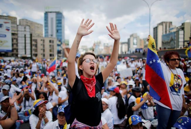 Protesters march in Venezuela, destroy Chavez statue | iNFOnews.ca