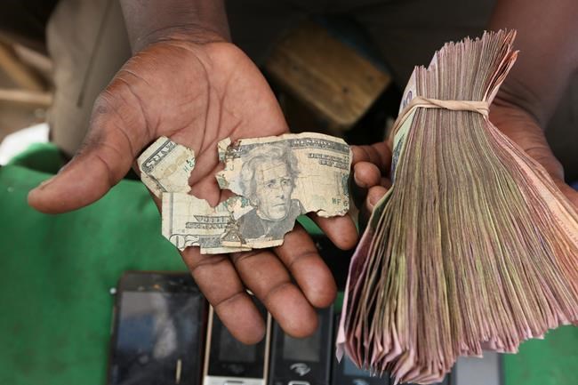 Zimbabweans mend shabby dollar notes amid economic crisis | iNFOnews.ca