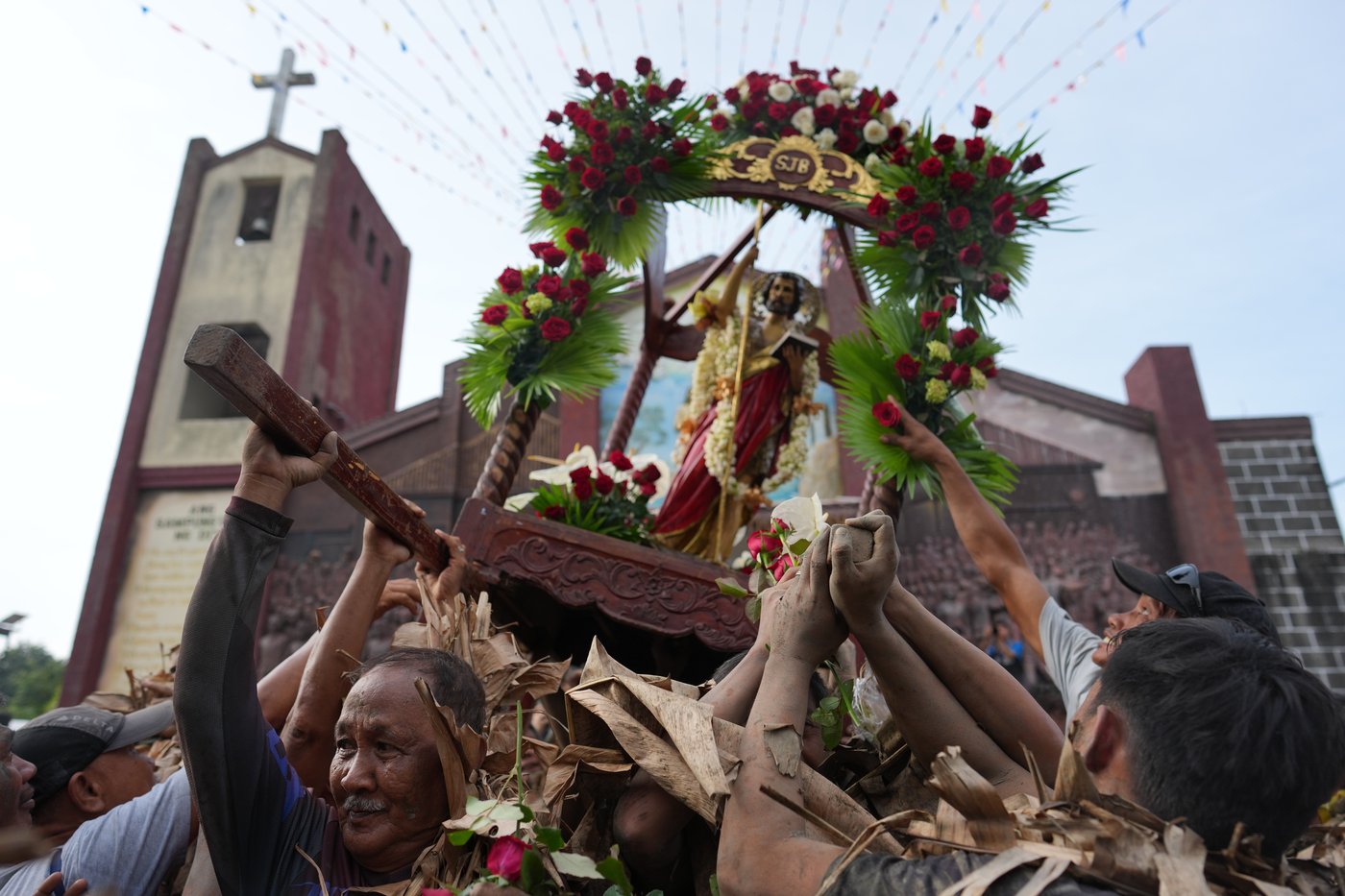 Photos show Philippine Catholics smearing mud on their bodies for festival honoring John the Baptist | iNFOnews.ca