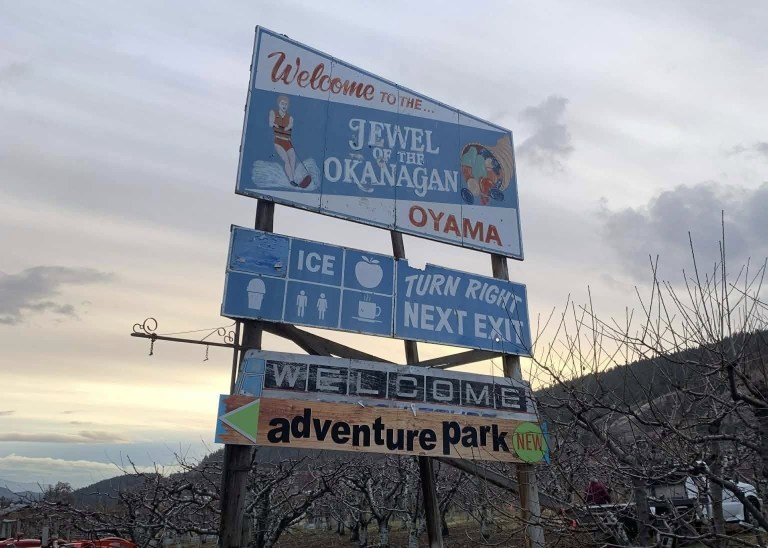 A tall wooden sign reads Welcome to the ... Jewel of the Okanagan Oyama.