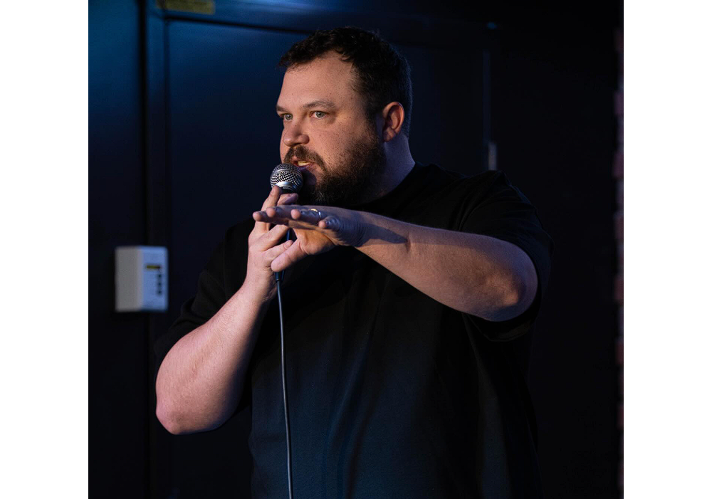 A man speaks into a microphone.