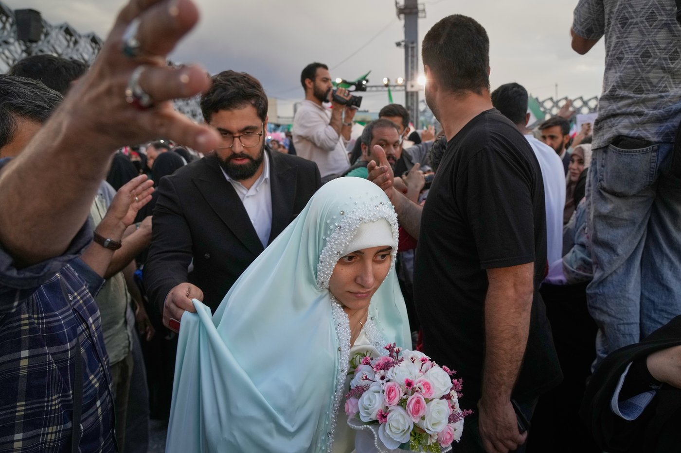 Photos of a mass wedding and a colorful missile at Tehran's 'Sacrifice for Iran' ceremony | iNFOnews.ca