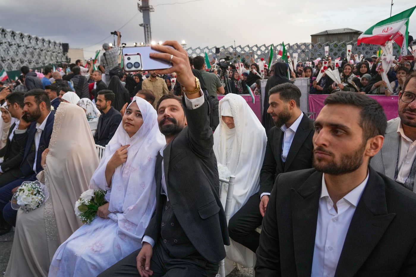 Photos of a mass wedding and a colorful missile at Tehran's 'Sacrifice for Iran' ceremony | iNFOnews.ca
