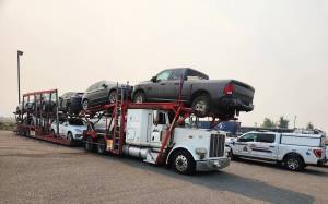 An auto transport truck pulled over on a highway.