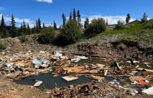 Waste piled in a flooded pit.
