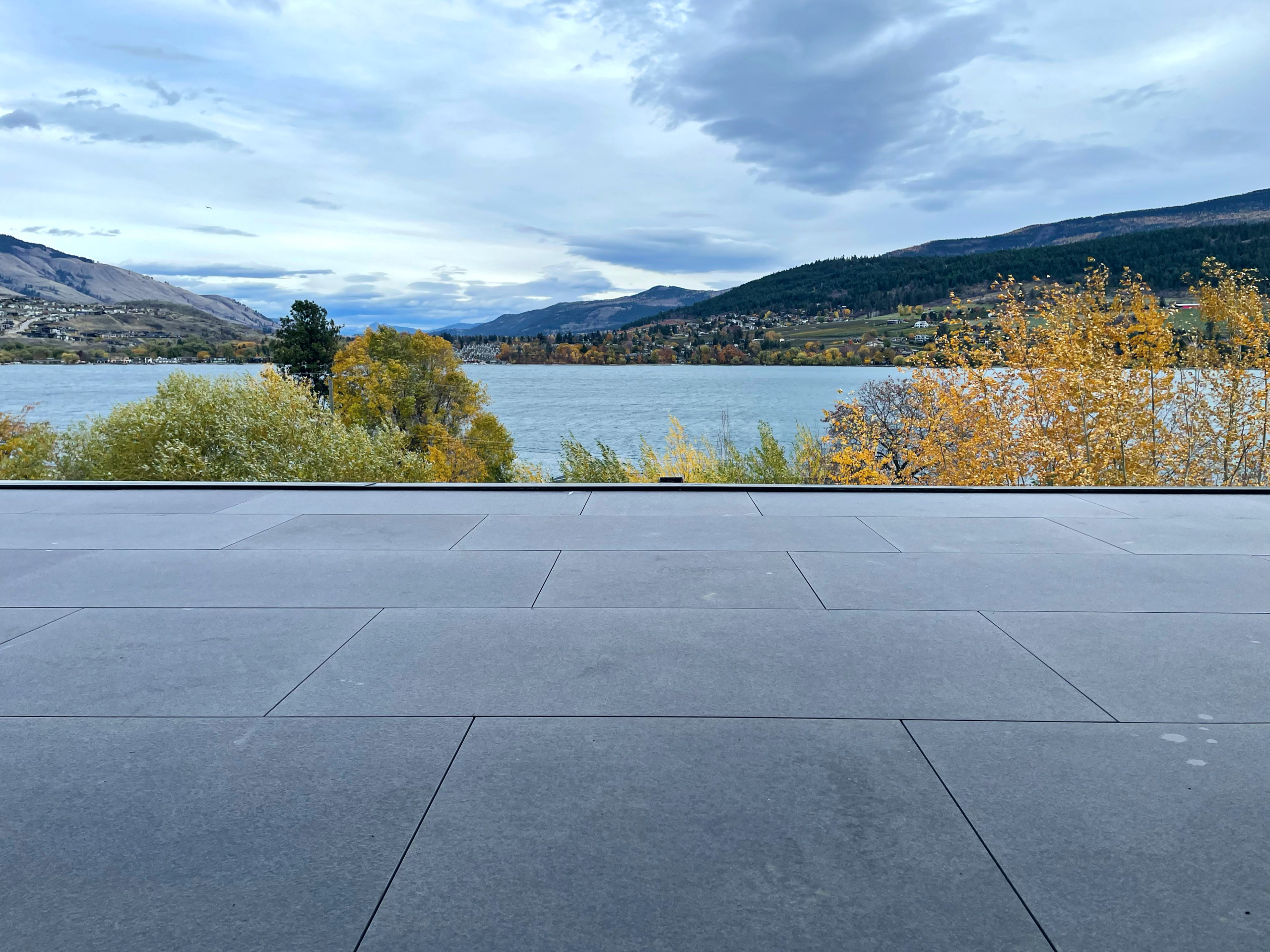 Exterior porcelain tile deck overlooking an Okanagan lake