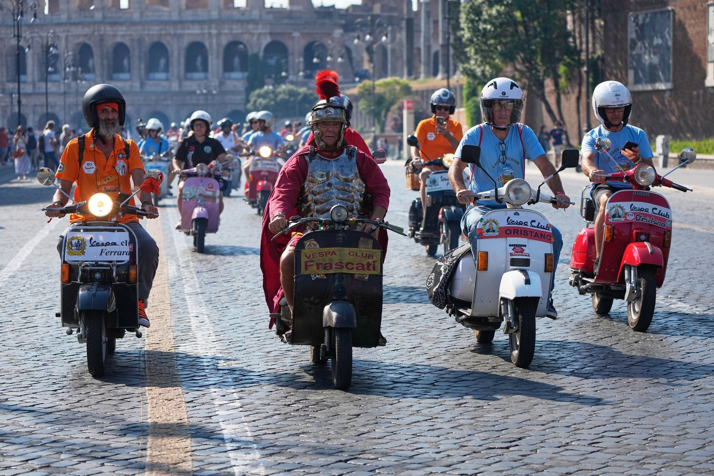 Photos show Vespa enthusiasts buzzing through Rome celebrating the little scooter's 80th anniversary | iNFOnews.ca