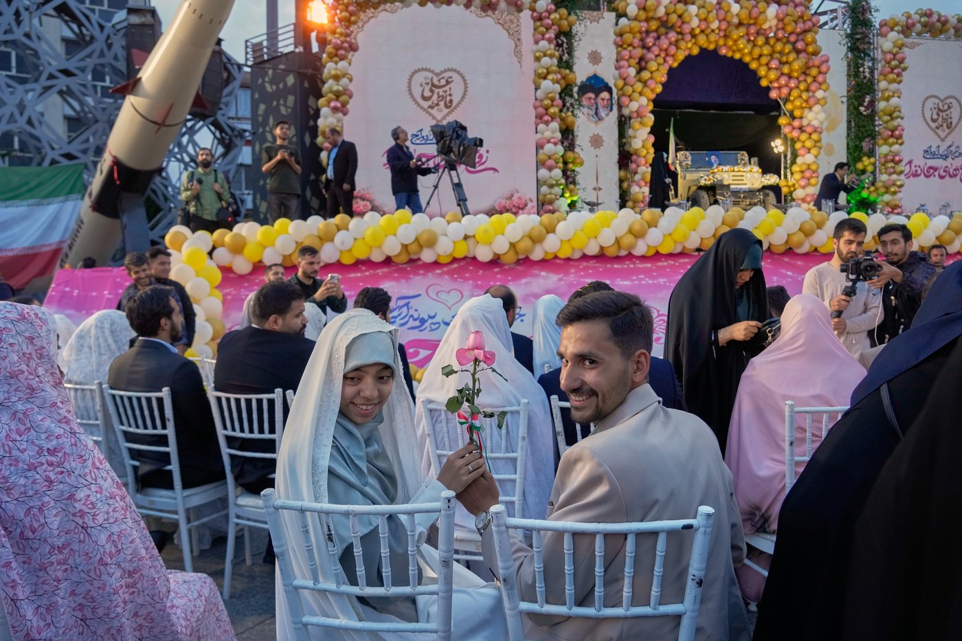 Photos of a mass wedding and a colorful missile at Tehran's 'Sacrifice for Iran' ceremony | iNFOnews.ca