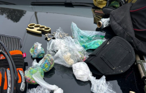 Drugs and weapons on the hood of a police car