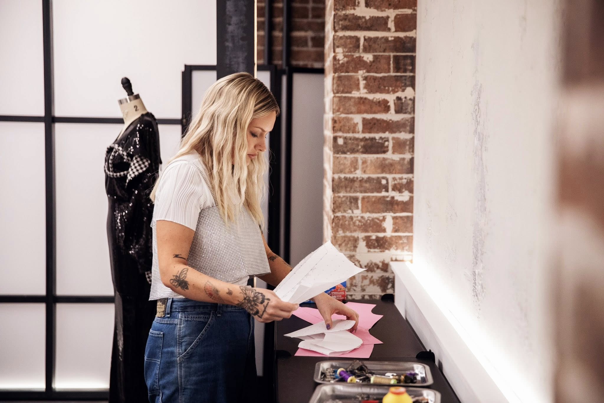 The picture shows a side profile of woman looking down at a sheet of paper in her hand.