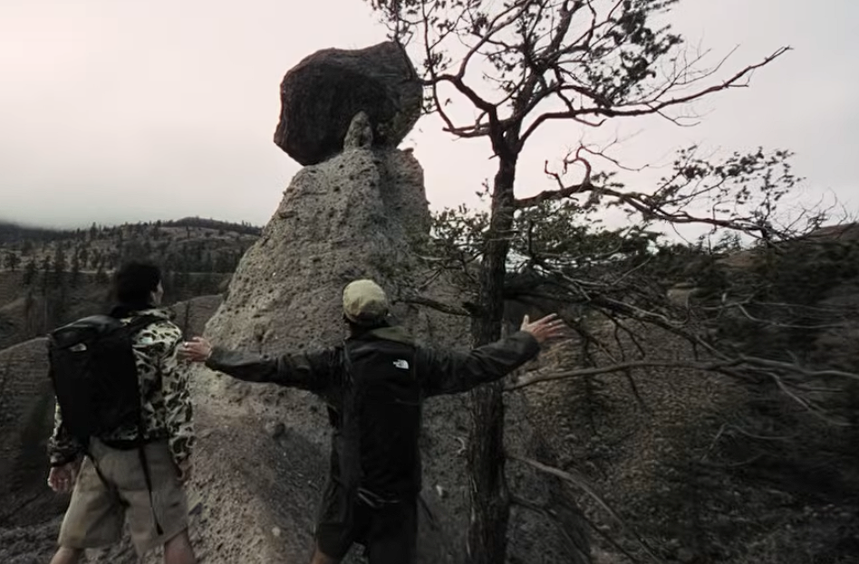 Two people stand on a hiking trail