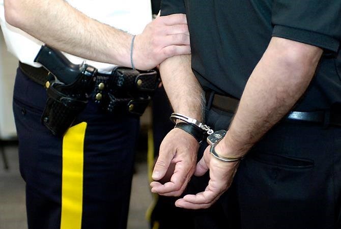 Man with hands in handcuffs.