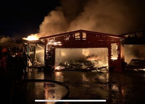 A garage totally engulfed in flames.