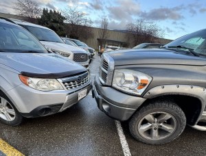 The noses of two parked vehicles are touching.