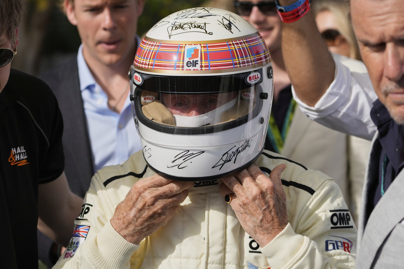 Michael Schumacher's signature on helmet worn by F1 champ Jackie Stewart at charity drive in Bahrain | iNFOnews.ca