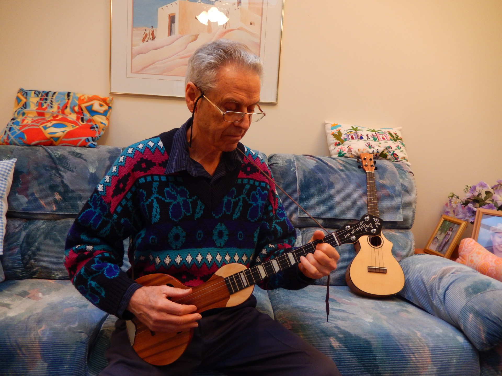 A man with an oddly shaped, four-string guitar.