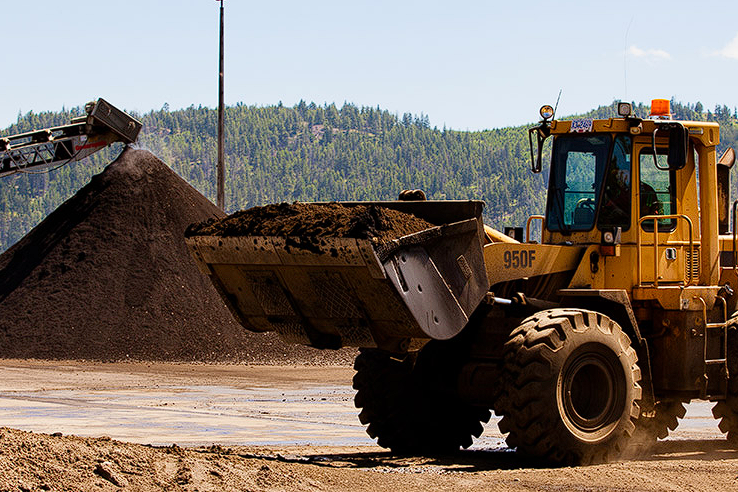 Heavy equipment carrying a load of soil.