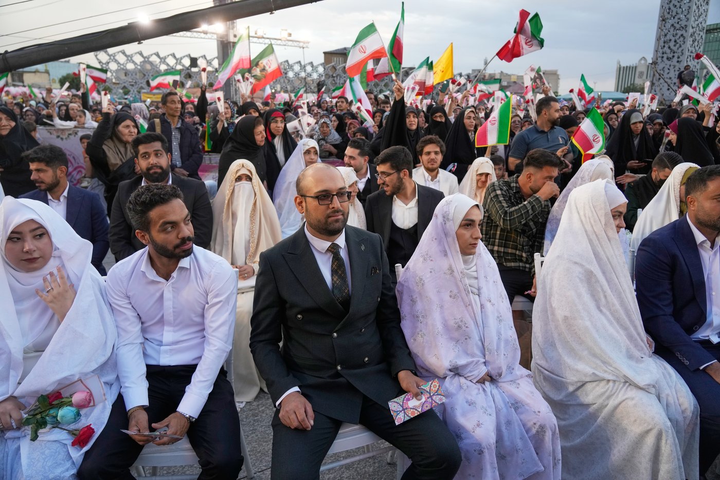 Photos of a mass wedding and a colorful missile at Tehran's 'Sacrifice for Iran' ceremony | iNFOnews.ca