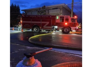 Firetruck in the rain with lights on.