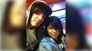 A man and woman pose for a photo.