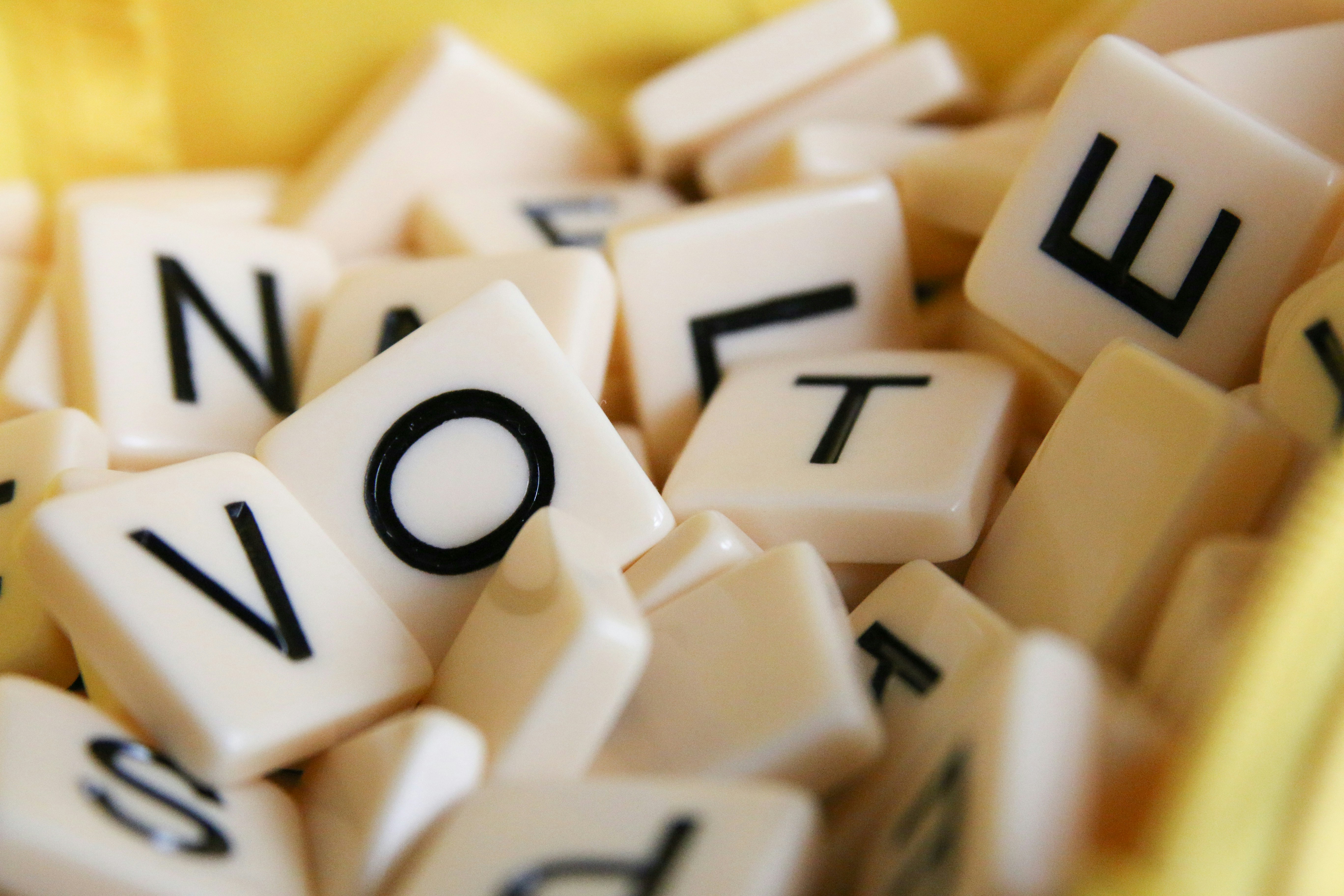 A jumble of Scabble tiles spelling the word vote.