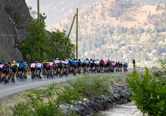 Cyclists race along a South Okanagan lakeside road.