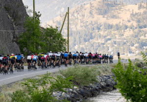 Cyclists race along a South Okanagan lakeside road.