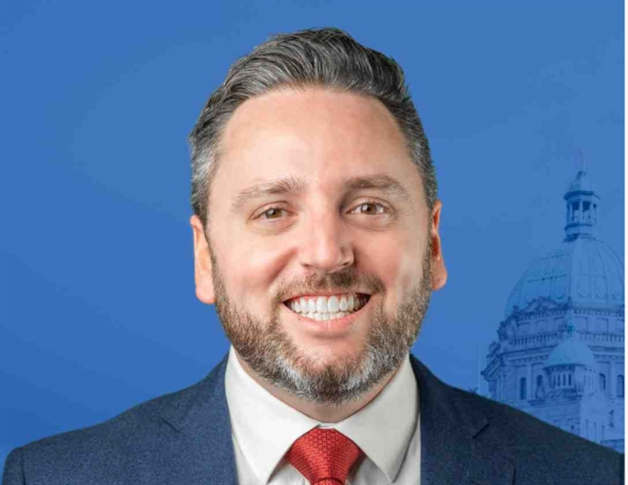 Headshot of a man in a suit.