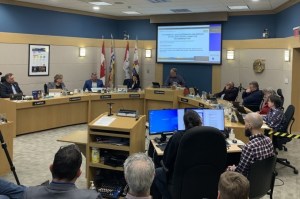 Mayor and city councillors seated in council chambers.
