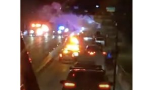 A blurry image of a van on fire on William R. Bennett bridge.
