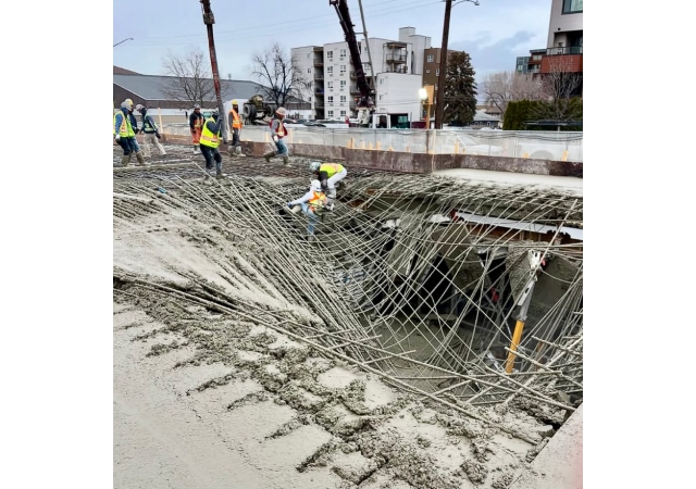 Construction workers at the scene of a concrete collapse.