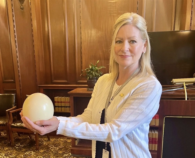 Tara Armstrong holding an ostrich egg.