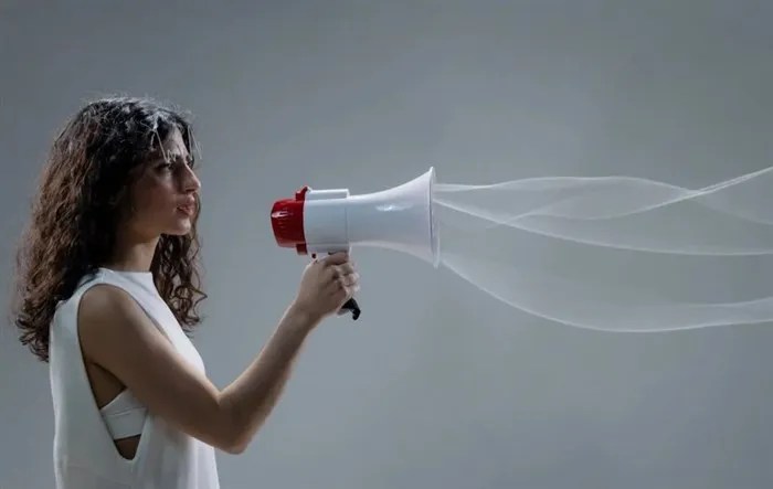 A woman speaks into a megaphone.