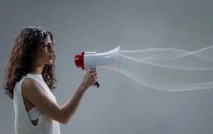 A woman speaks into a megaphone.